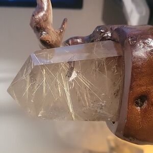 large golden rutile on stand